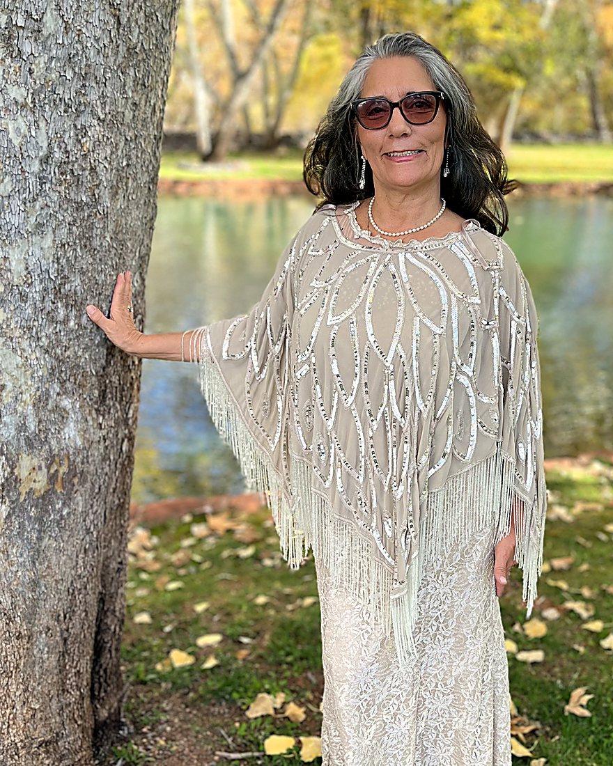 Sharon Shapiro standing by a tree beside a creek in Sedona