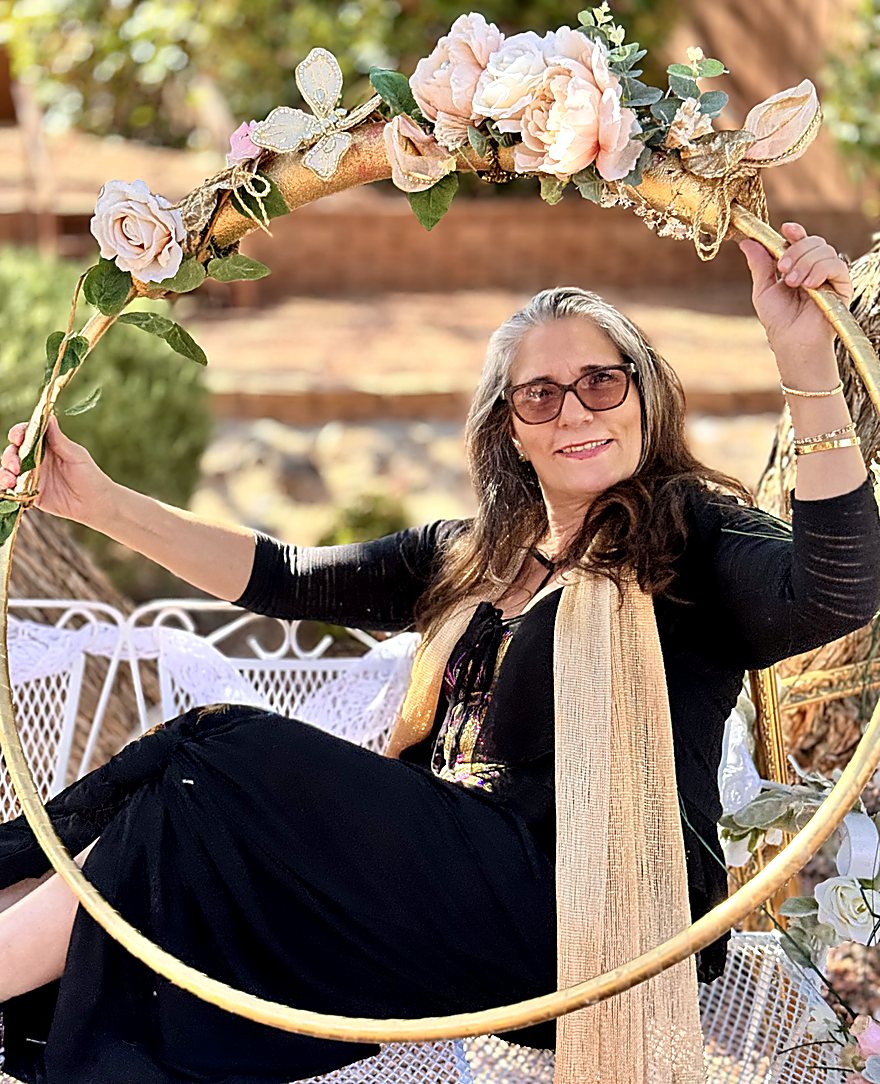 Sharon Shapiro smiling inside a gold hoop decorated with flowers
