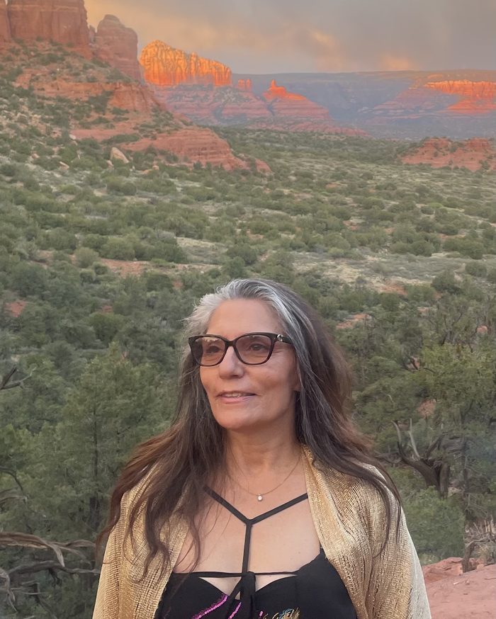 Sharon Shapiro at sunset with the red rocks of Sedona behind her